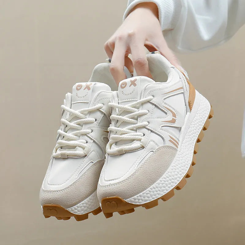 Women's black platform casual sneakers with round toe and front lace-up, showing artificial PU upper and flat sole.