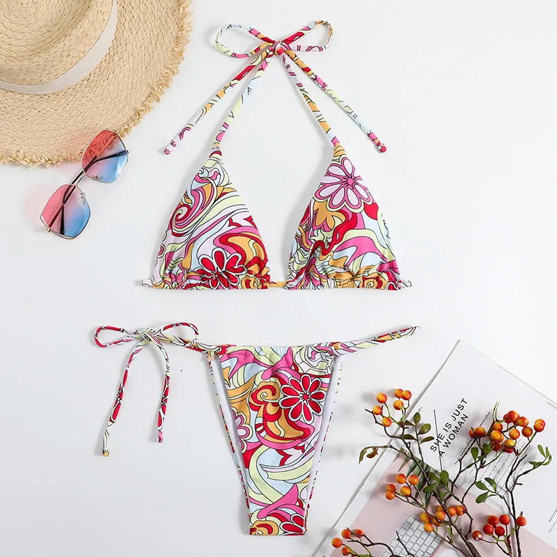 Multicolor printed women's triangle bikini top with hanging neck and matching bottoms.
