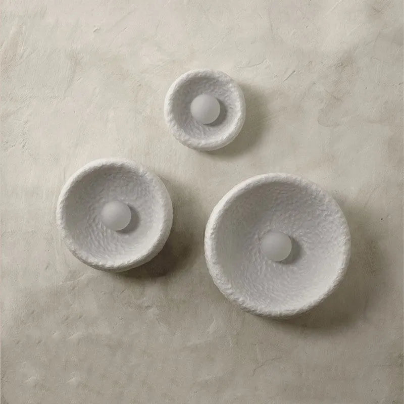 Japanese-style simple silent wall lamp with a white resin shade in three size diameters.