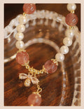 Women's strawberry quartz bracelet with stringed pearls and bow detail in INS style