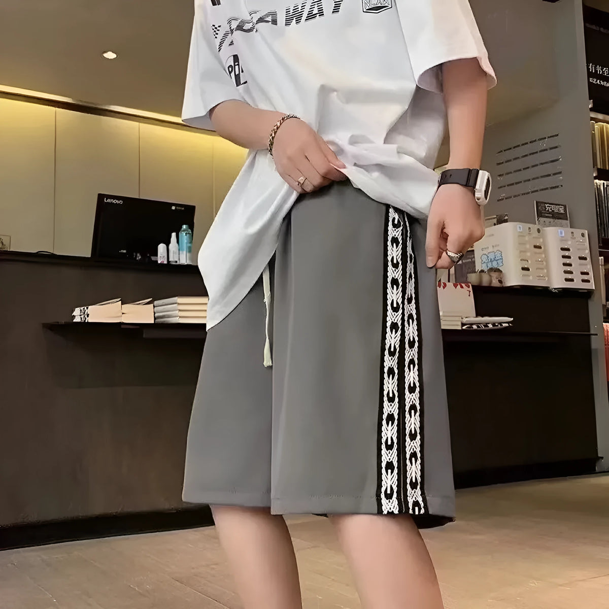Men's loose-fit casual track pants in black with micro-elastic fabric and sports-style design
