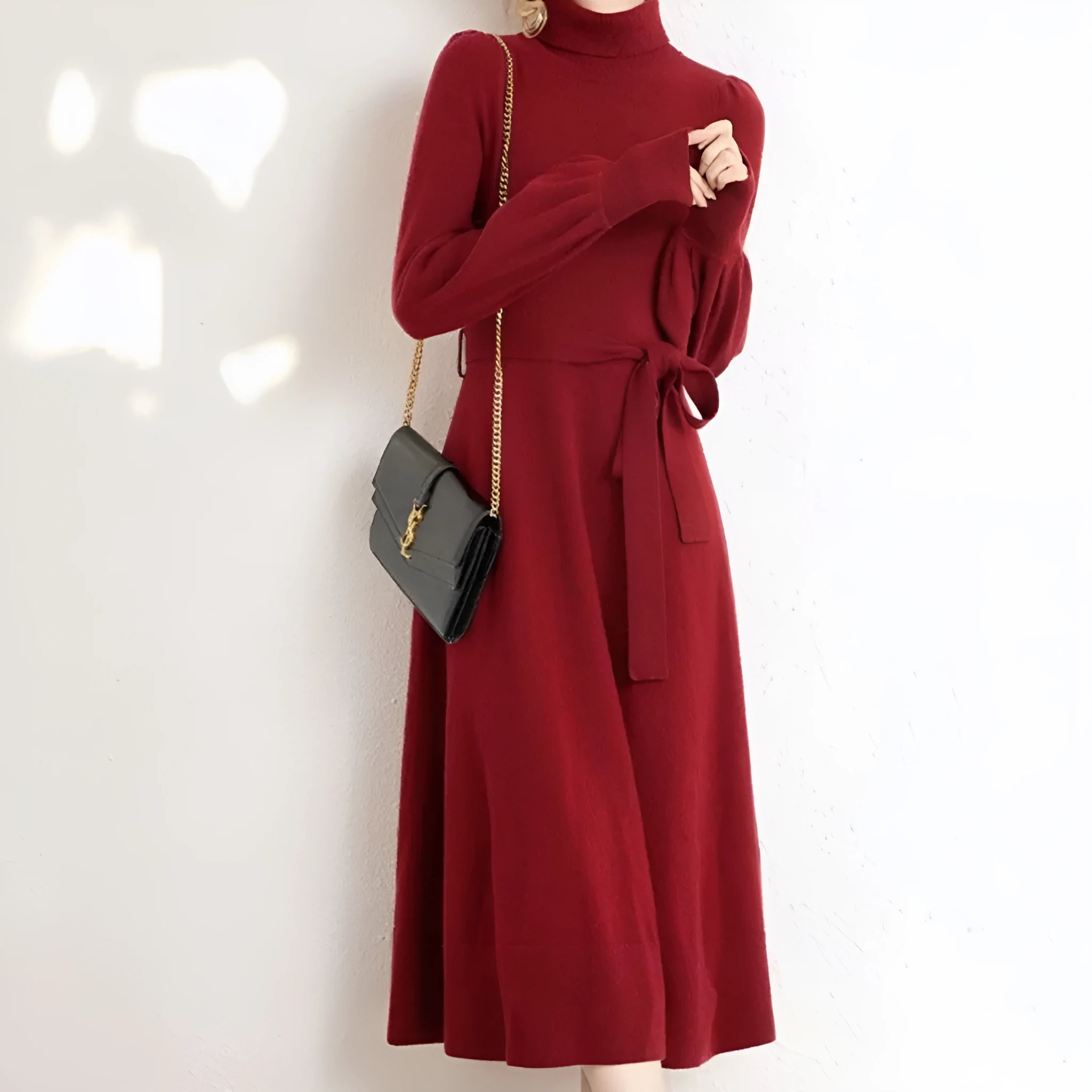 A rose red knitted turtleneck dress with long sleeves, an elastic waist, and a loose mid-length skirt.