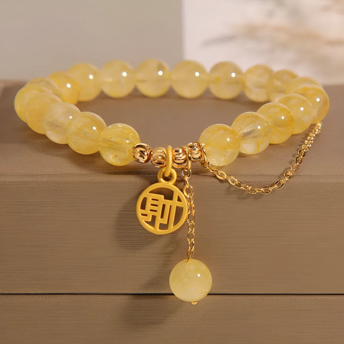 Natural citrine bracelet with Chinese character charm and decorative tassel in electroplated mixed materials