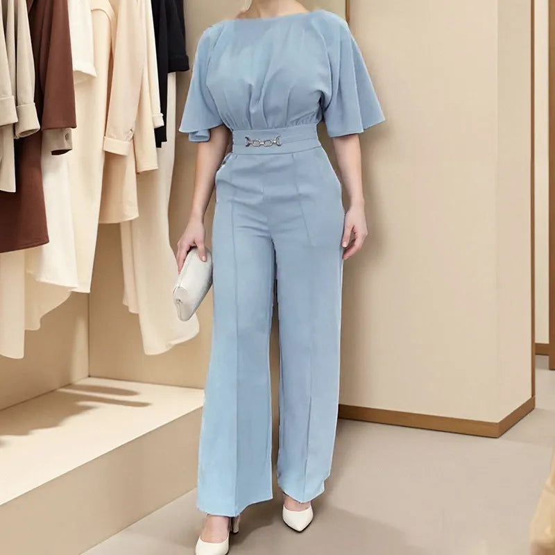Men's blue polyester two-piece suit with long sleeve jacket and trousers on a hanger.