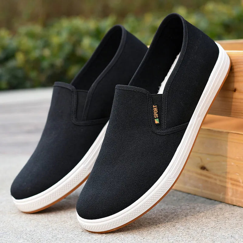 Men's black and blue canvas slip-on shoes with round toe and low-top design on composite sole