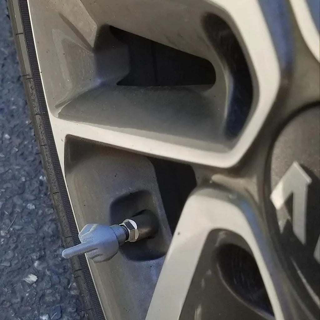 Four latex tyre valve dry caps showing black and skin tone finishes for car wheel protection