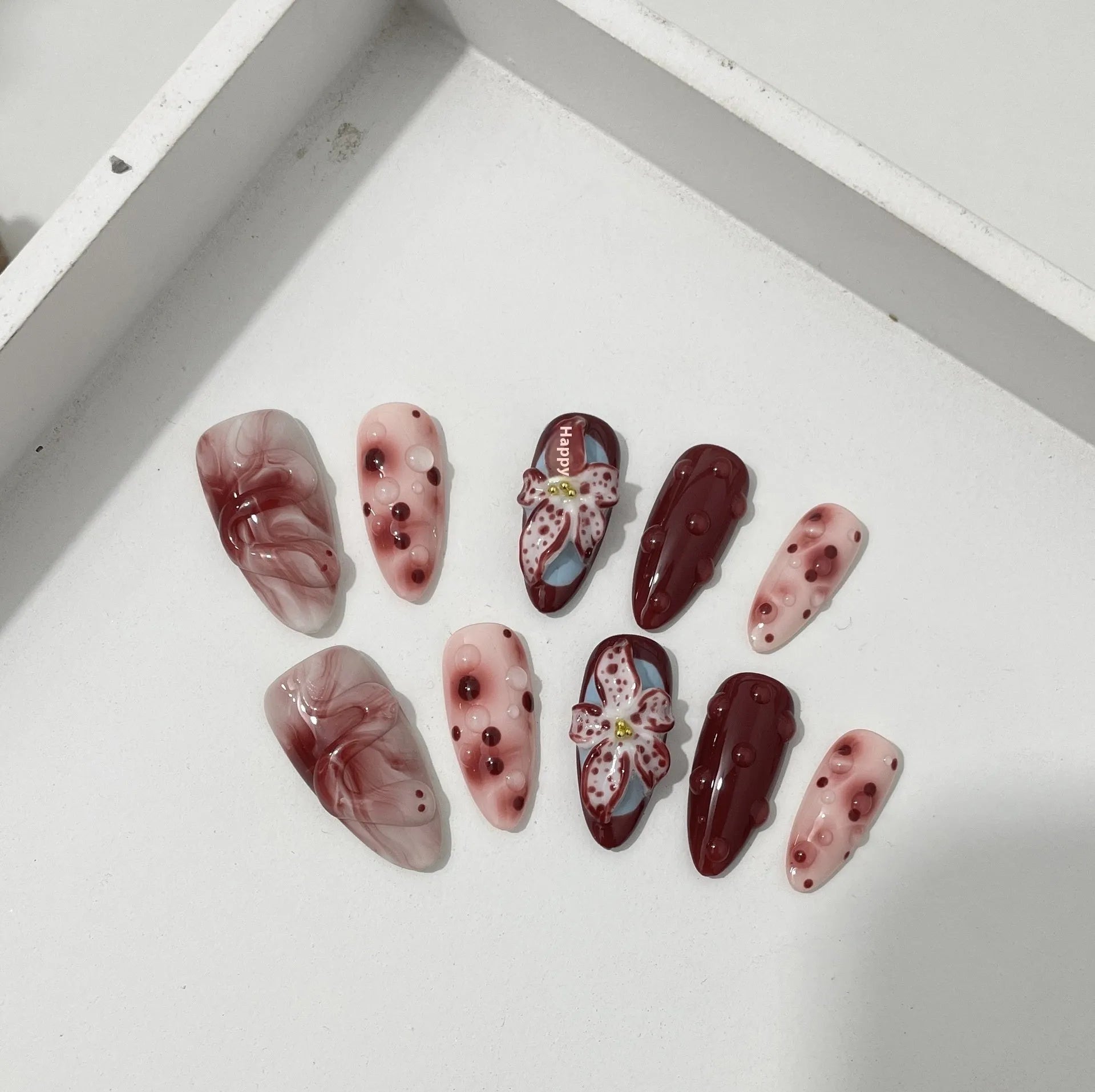 Hand-painted 3D carved manicure nail art set in almond colour with rose, tulip, and leopard print patterns