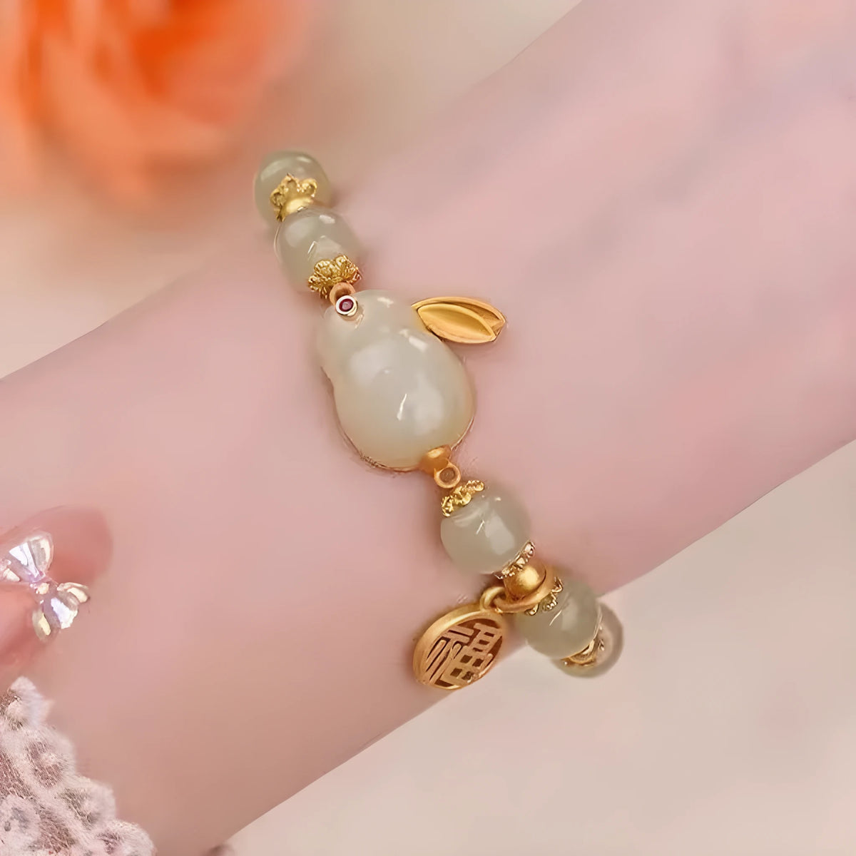 Green jade hare bracelet with black base, fu character design, and lily decorative elements