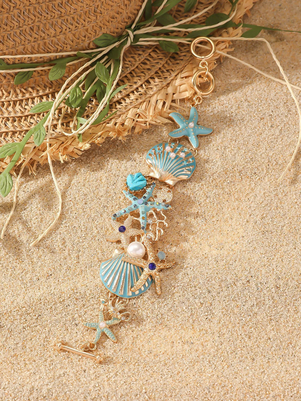Women's alloy bracelet with marine shell, boat anchor, and starfish design in blue, red, or turquoise.