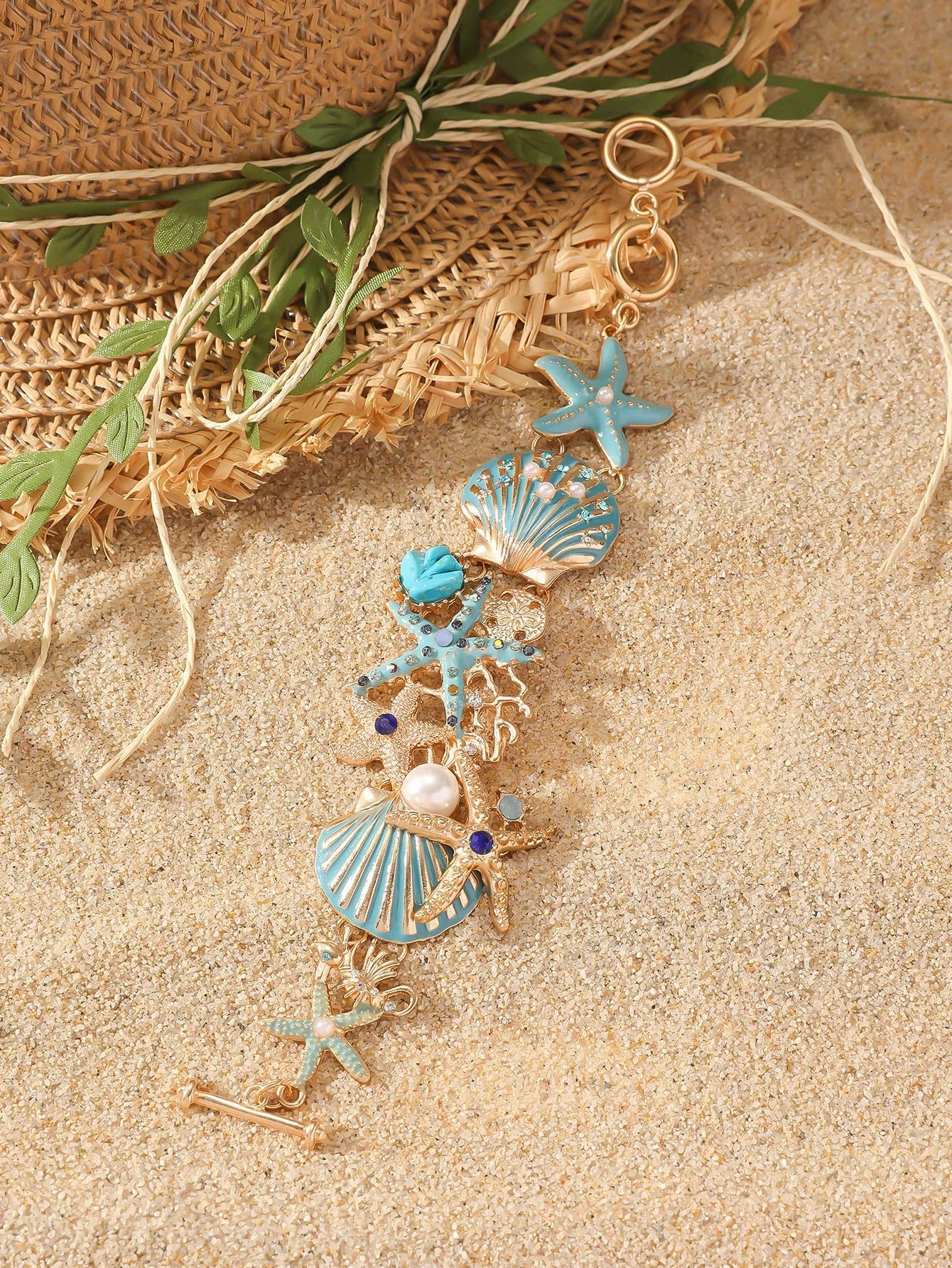 Women's alloy bracelet with marine shell, boat anchor, and starfish design in blue, red, or turquoise.