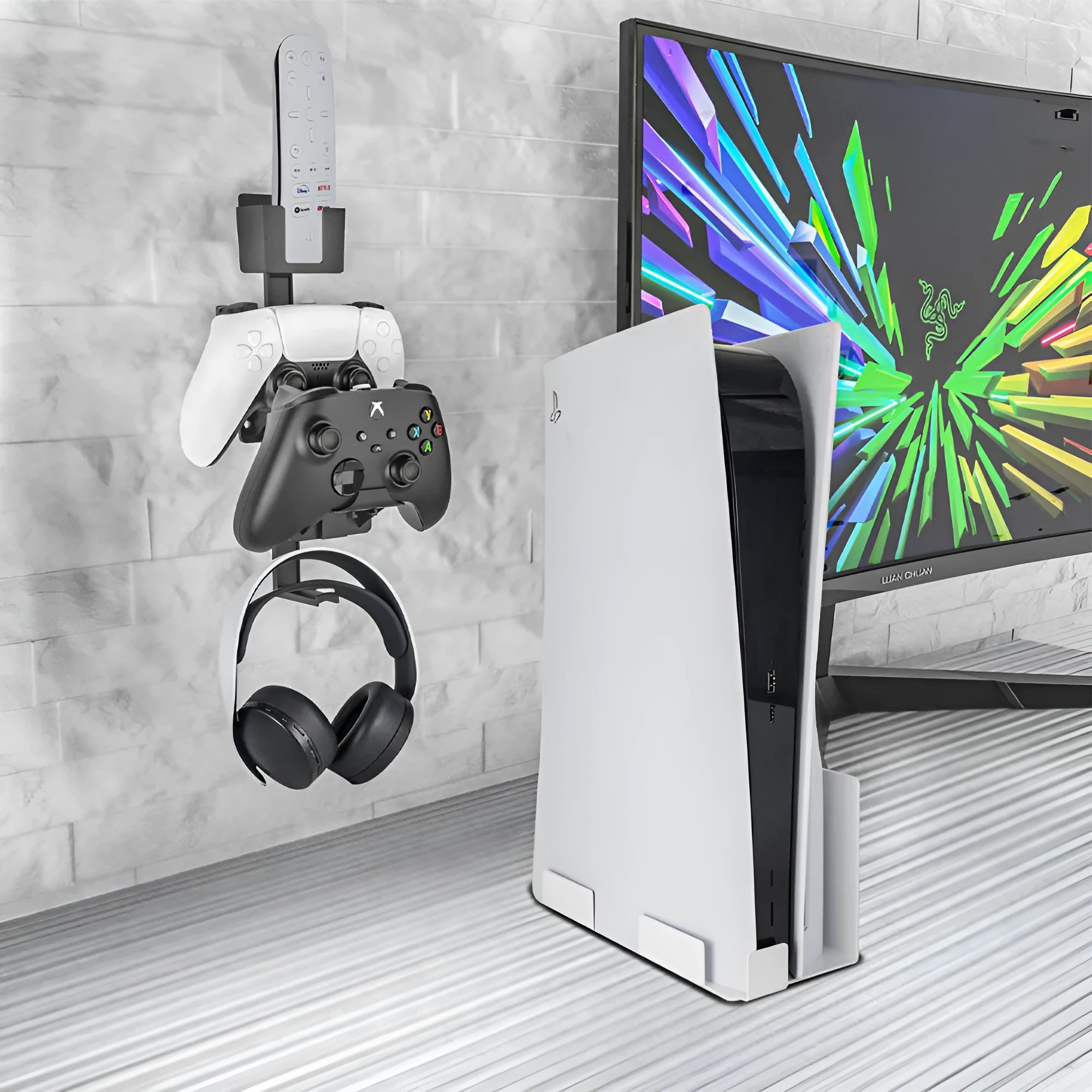 White ABS plastic wall hook holding a PS5 controller and headphones