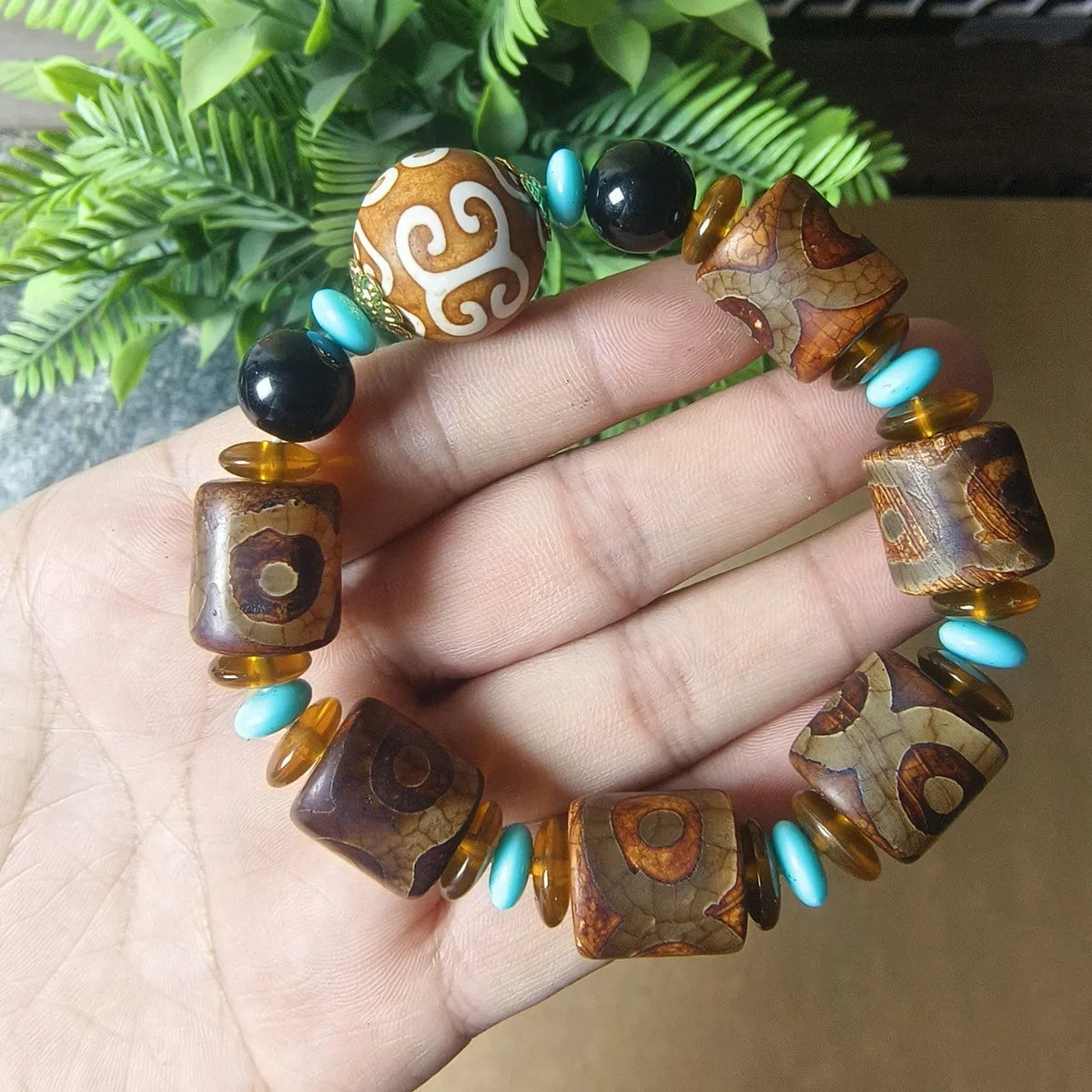 Handmade distressed agate dzi bead bracelet with polished Tibet beads on wrist