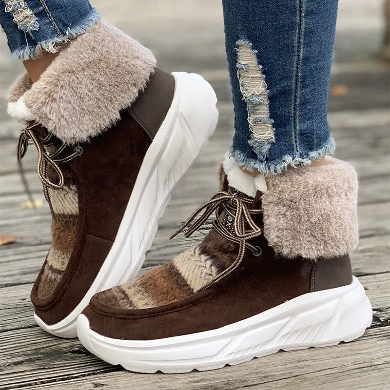 Women's beige lace-up snow boots with thermal lining and rubber sole on wooden surface