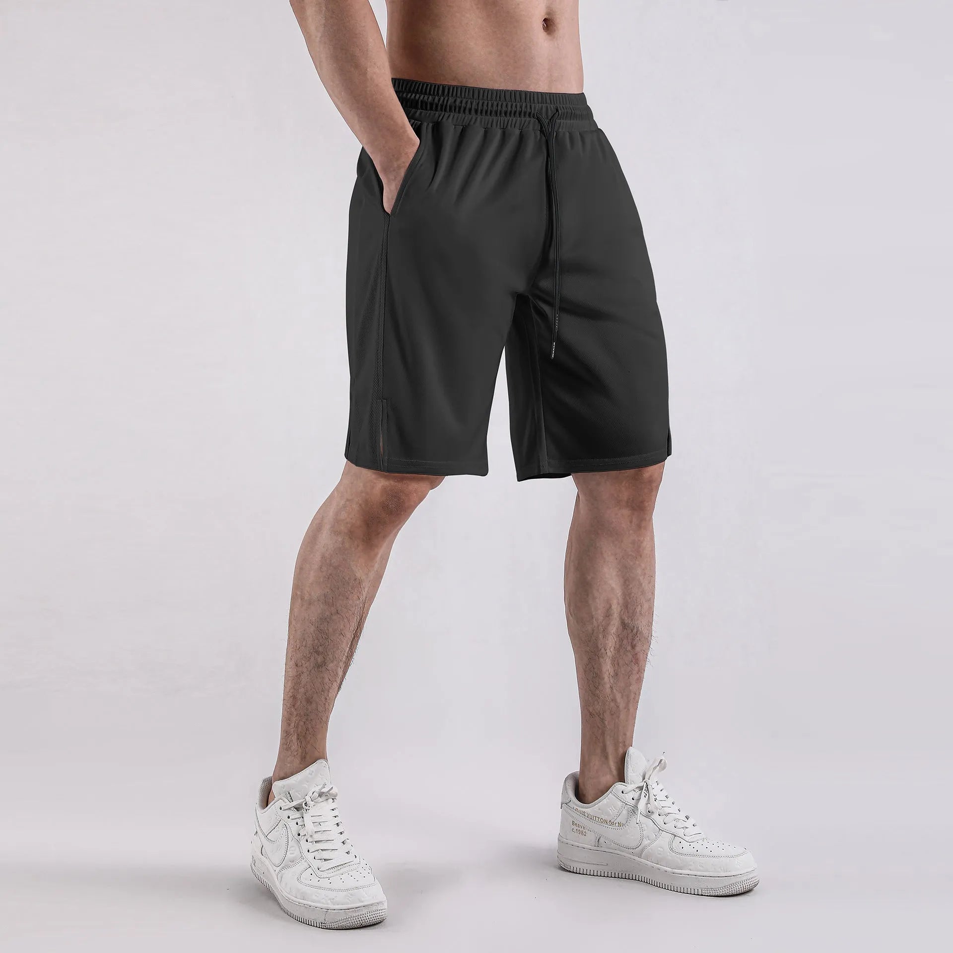 Men's black and white quick-drying loose-fit mesh shorts with elastic waistband.
