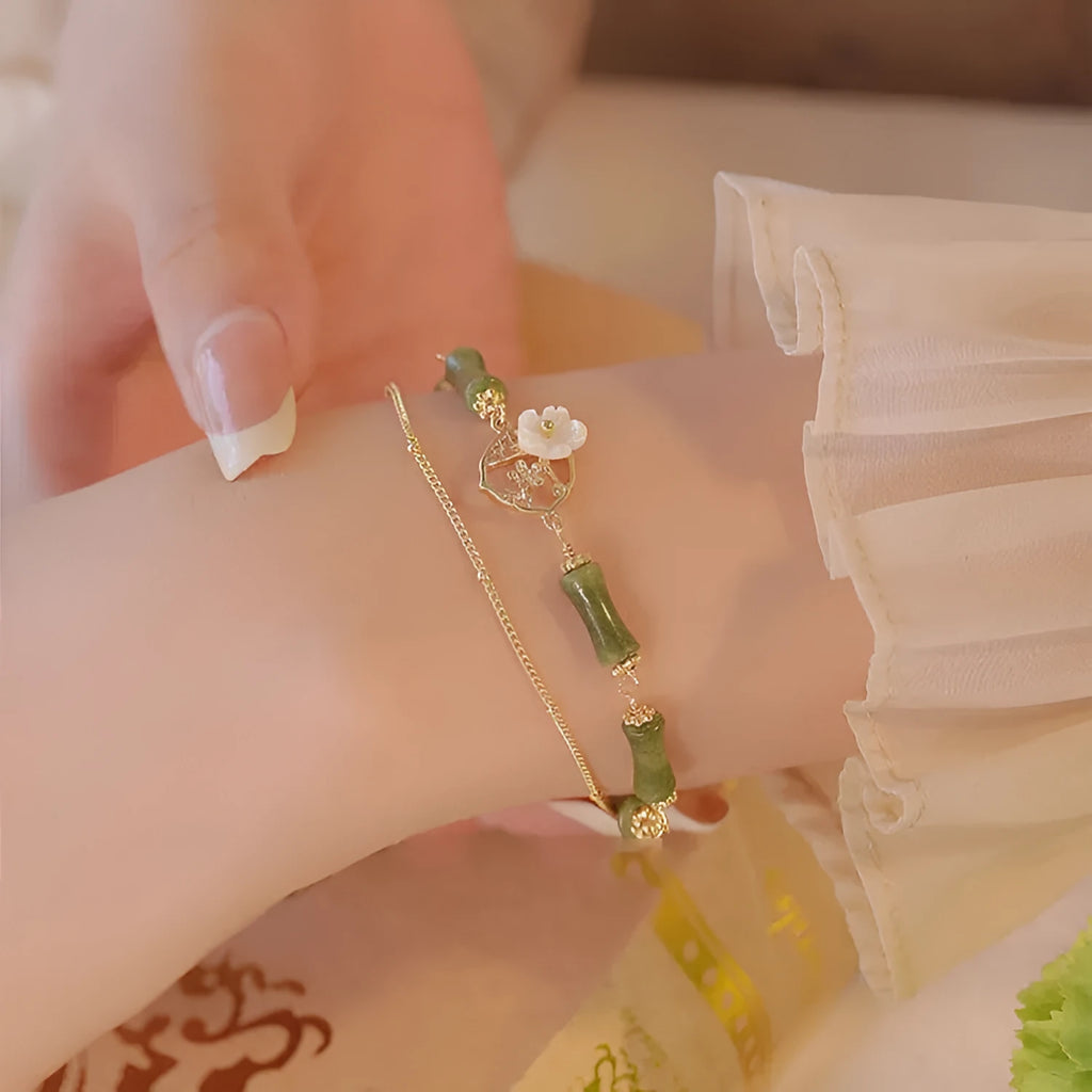 Handcrafted green olivine bracelet with double layer twin bells and olive branch design.