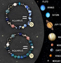 Set of two natural stone beaded bracelets featuring different zodiac sign designs on a wrist.