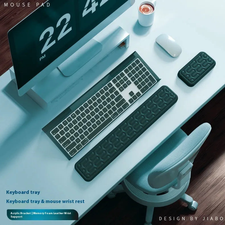 Double-sided black resin keyboard and mouse desk pad with integrated memory foam wrist rest.