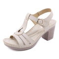 Women's patent leather high heel sandals with a metal buckle and thick heel in apricot colour.