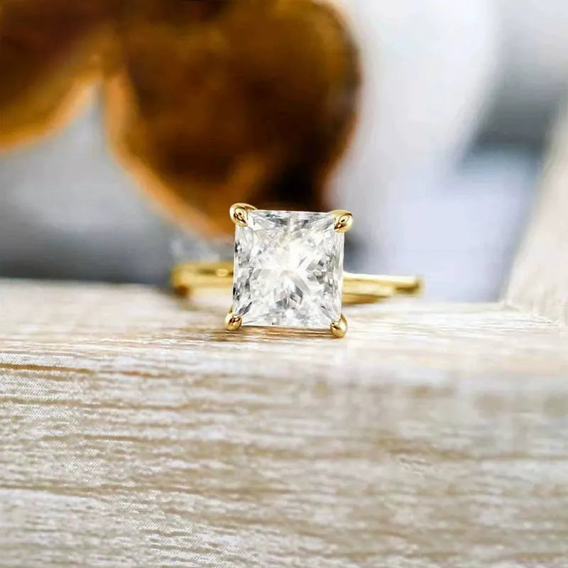 A simple geometric sterling silver ring with a round polished zirconium stone, shown in silver colour.