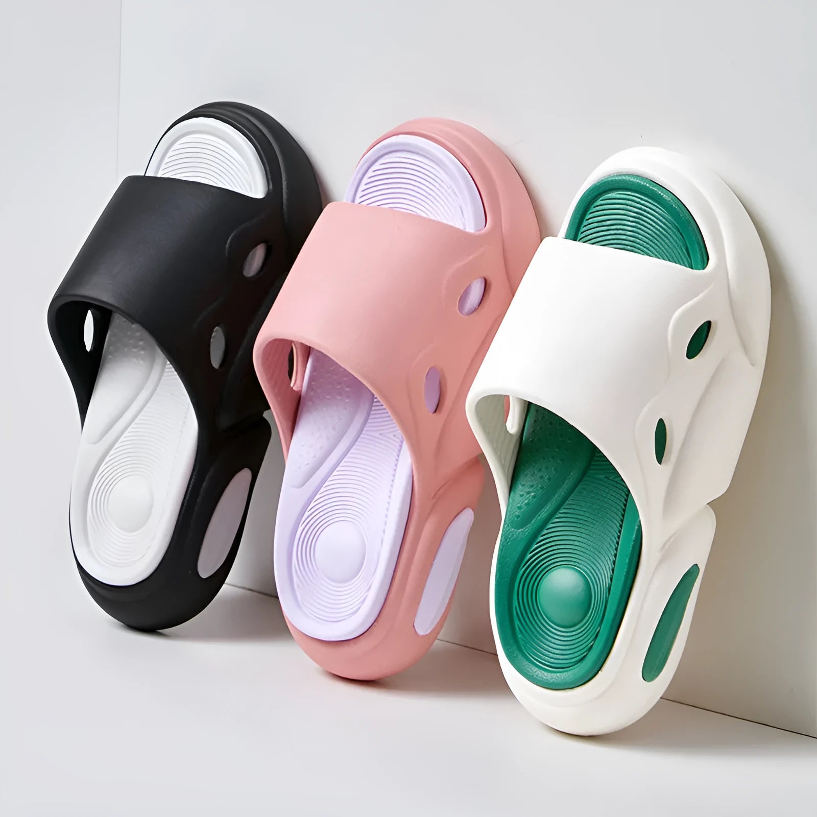 Women's two-colour EVA slippers with thick sole and leather lining in pink purple, shown on a foot.