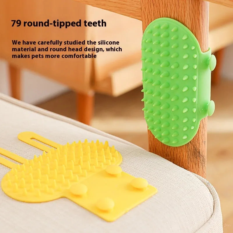 Silicone cat grooming comb with adjustable strap mounted on a table leg, shown in yellow.