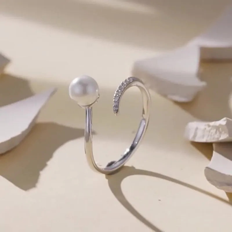 Sterling silver adjustable ring with natural shell pearls on open band design
