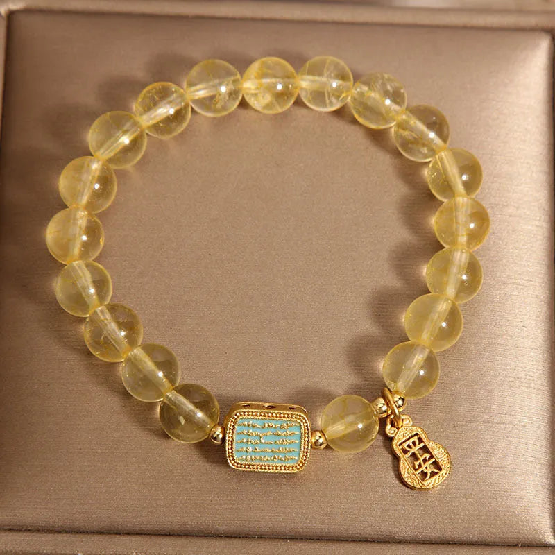 Citrine yellow crystal women's bracelet with sparkling rhinestone decorative elements.