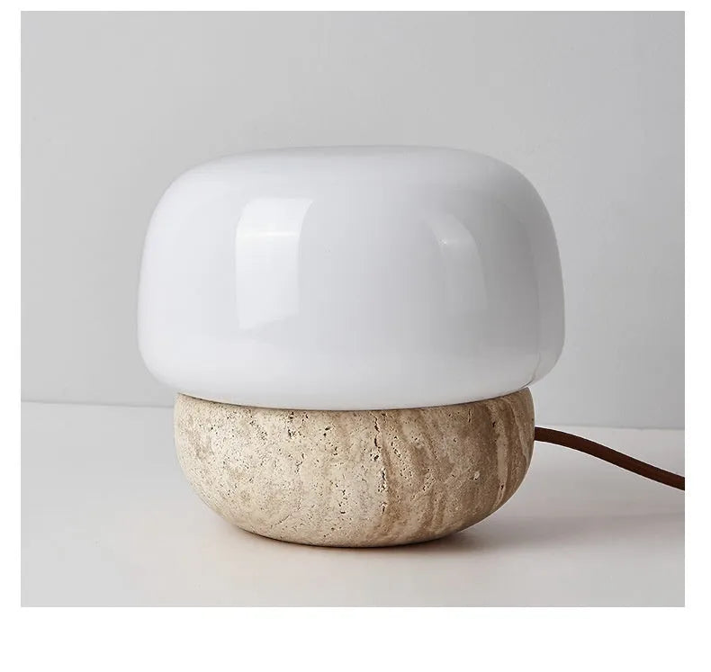 Cream coloured retro bedside lamp with a button switch on a wooden surface.