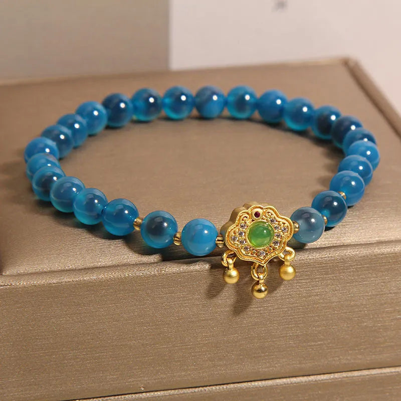 Blue sugar heart agate safety lock pendant on a crystal women's bracelet with alloy inlay and rhinestones.