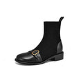 A pair of black women's lace-up Martin boots with a round toe and low rubber sole on a white background.