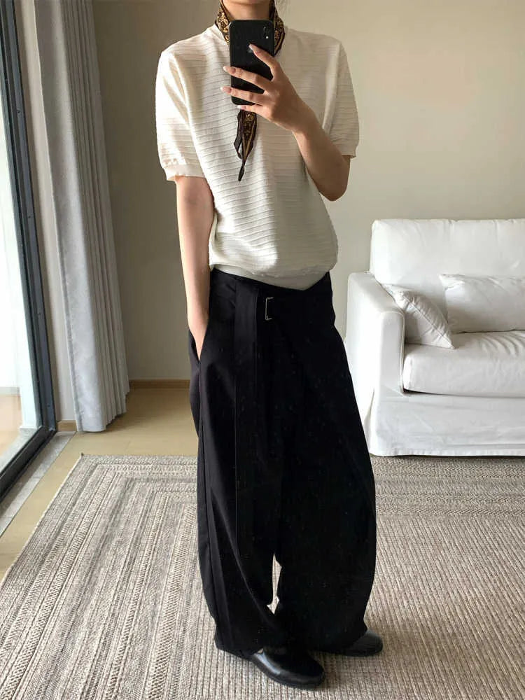 Black straight-leg women's trousers with a front pleat and adjustable waistband on a hanger.