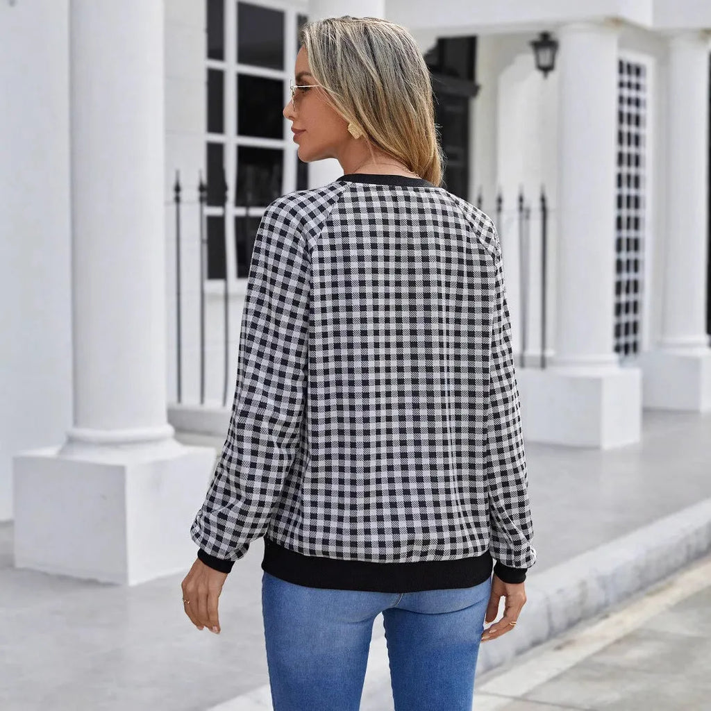 Black plaid print pullover sweater with long sleeves on mannequin
