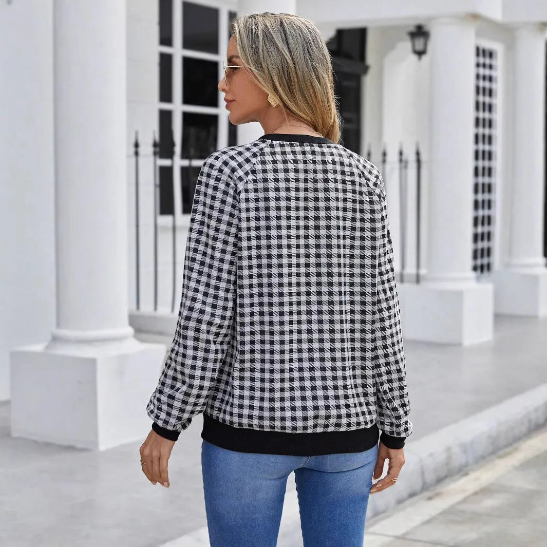 Black plaid print pullover sweater with long sleeves on mannequin