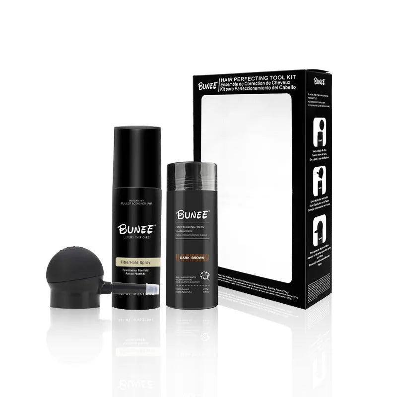 Canister of hair thickening fibre powder with nozzle and bottle of styling spray for thinning hair