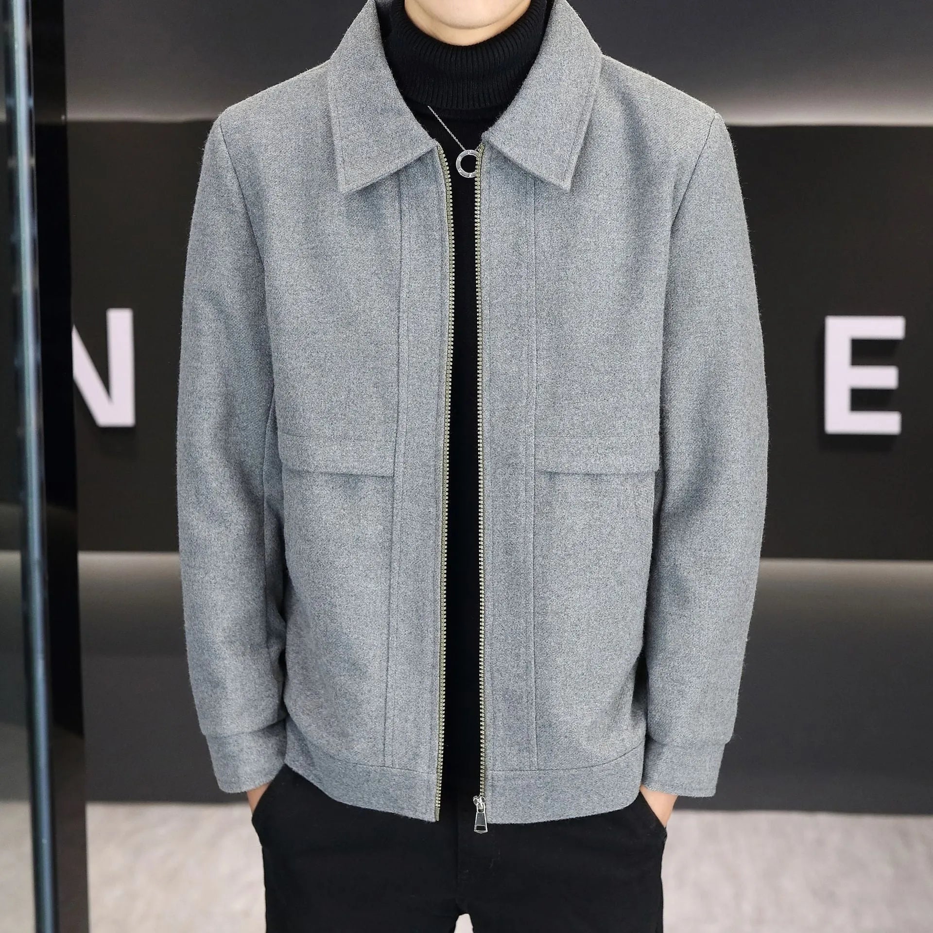 Man wearing a khaki polo collar casual jacket with side seam pockets.
