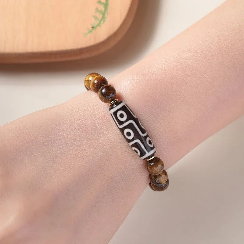 Simple Tigereye Dzi bead Buddha bracelet with single bead design on wrist