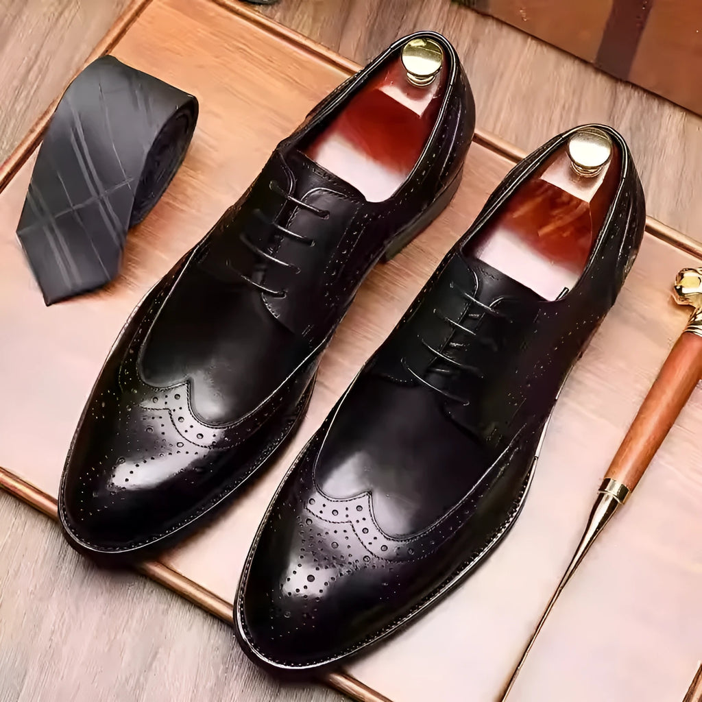 Men's burgundy leather brogue shoes with carved patterns, pointed toe, and low flat heel for formal occasions