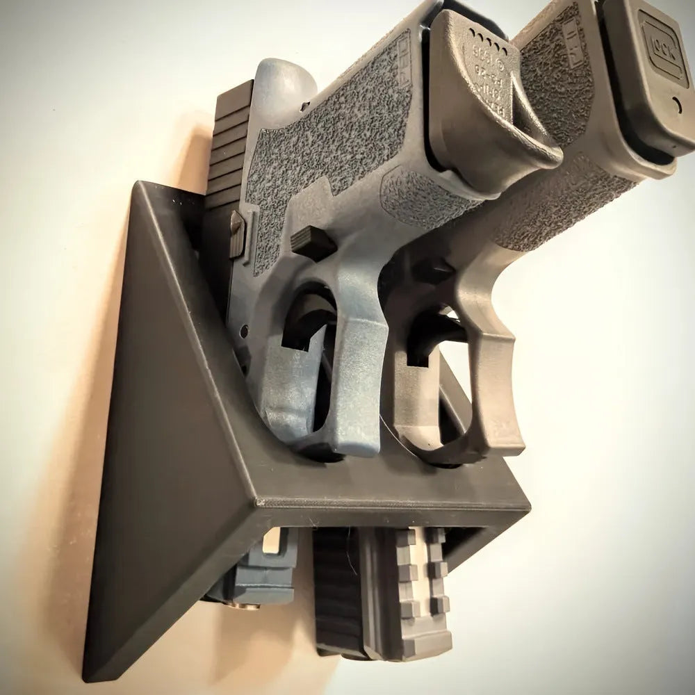 Black plastic pistol stand with punk-style design for displaying model firearms
