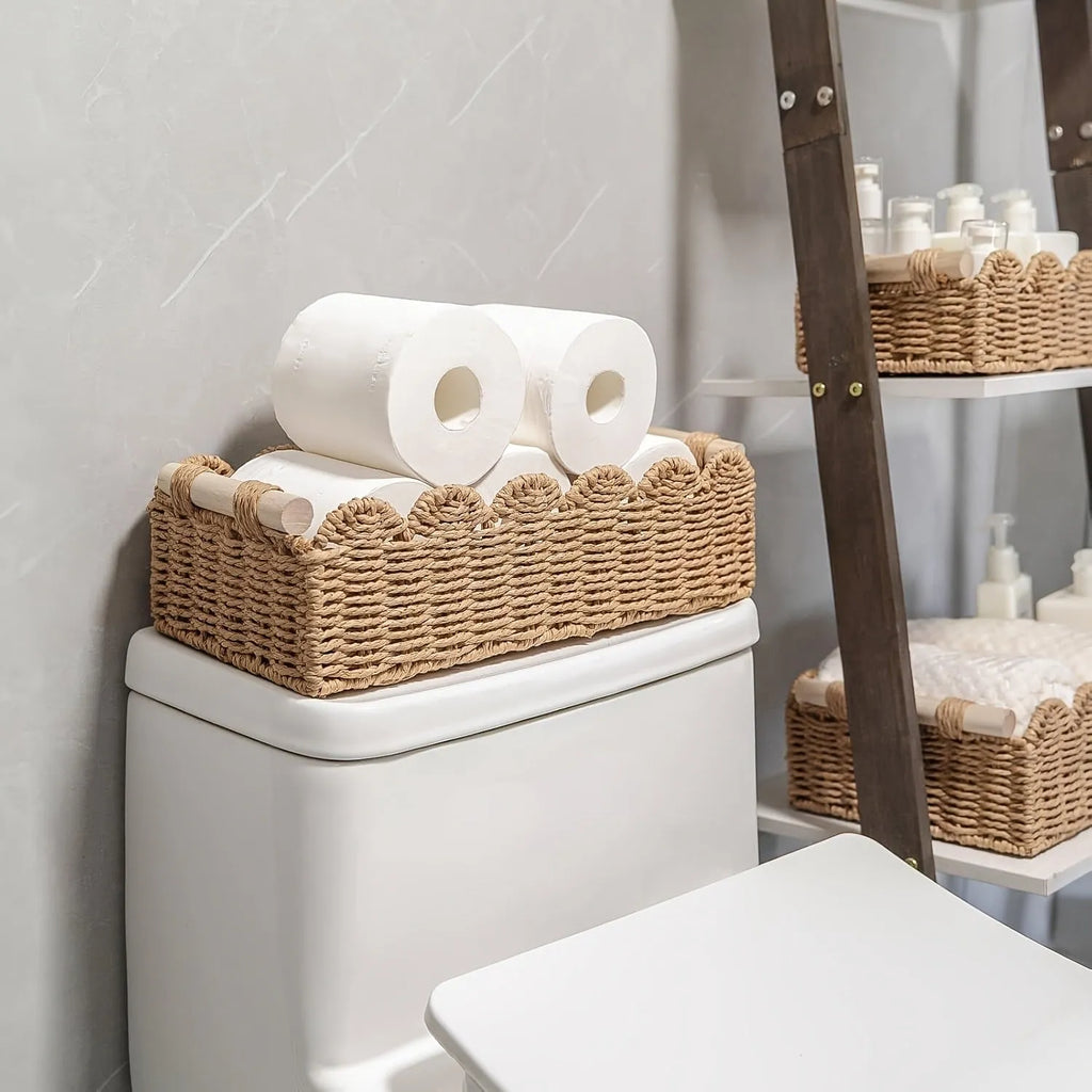 Rectangular woven paper storage basket in khaki colour on a wooden table.