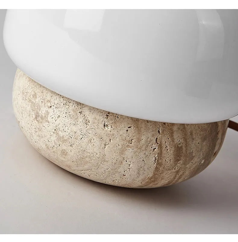 Cream coloured retro bedside lamp with a button switch on a wooden surface.
