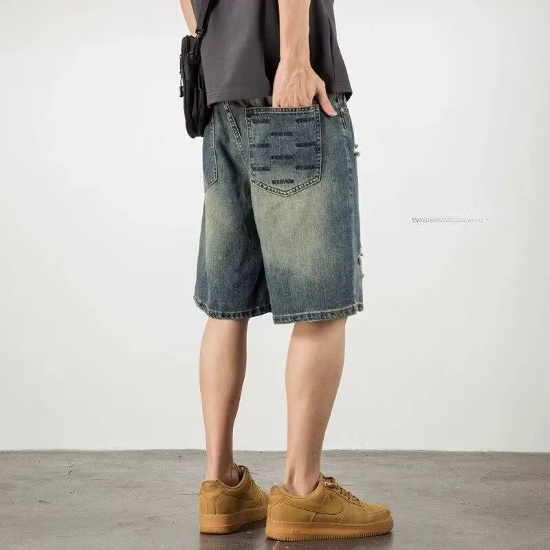 Man wearing blue retro-style loose denim shorts with a straight leg cut.