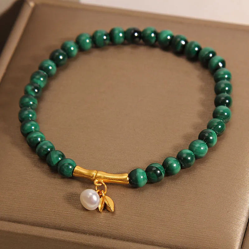 Close-up of a women's adjustable crystal bracelet with a white Lucky Bamboo design on wrist.