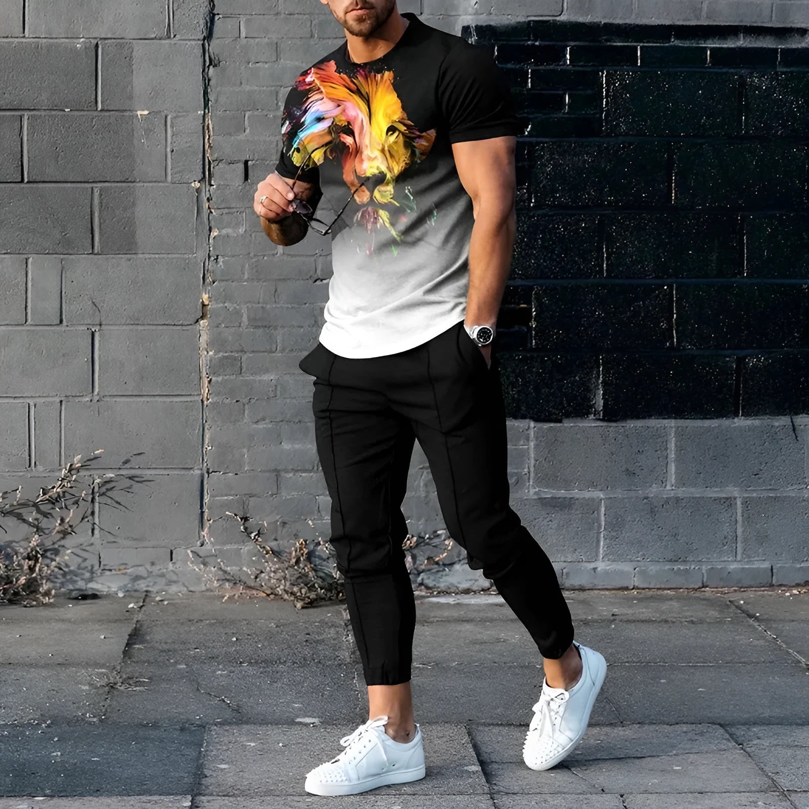 Men's short-sleeved printed sport suit set showing t-shirt and trousers in polyester blend fabric