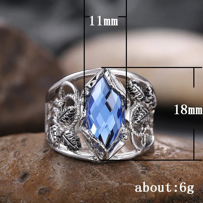 Blue crystal inlay horse eye-shaped geometric alloy ring for women on a plain background.