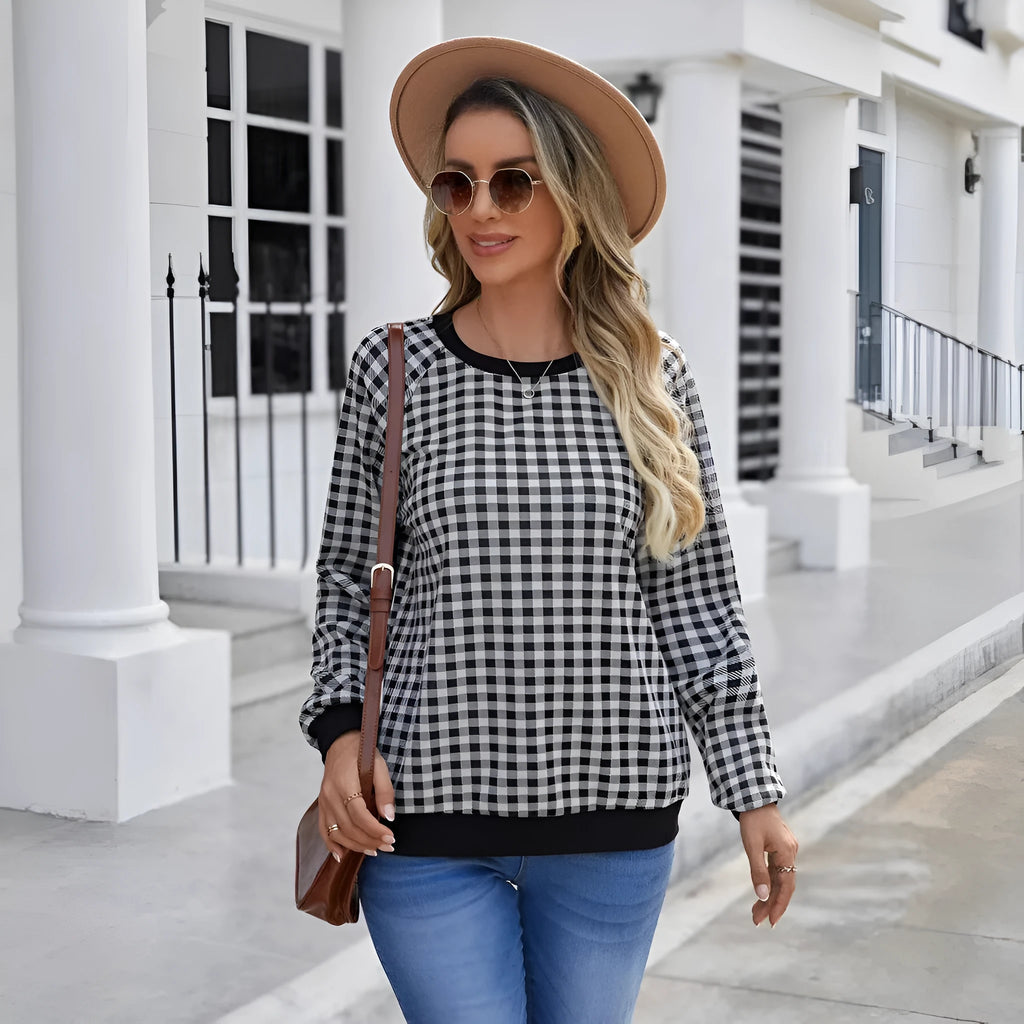 Black plaid print pullover sweater with long sleeves on mannequin