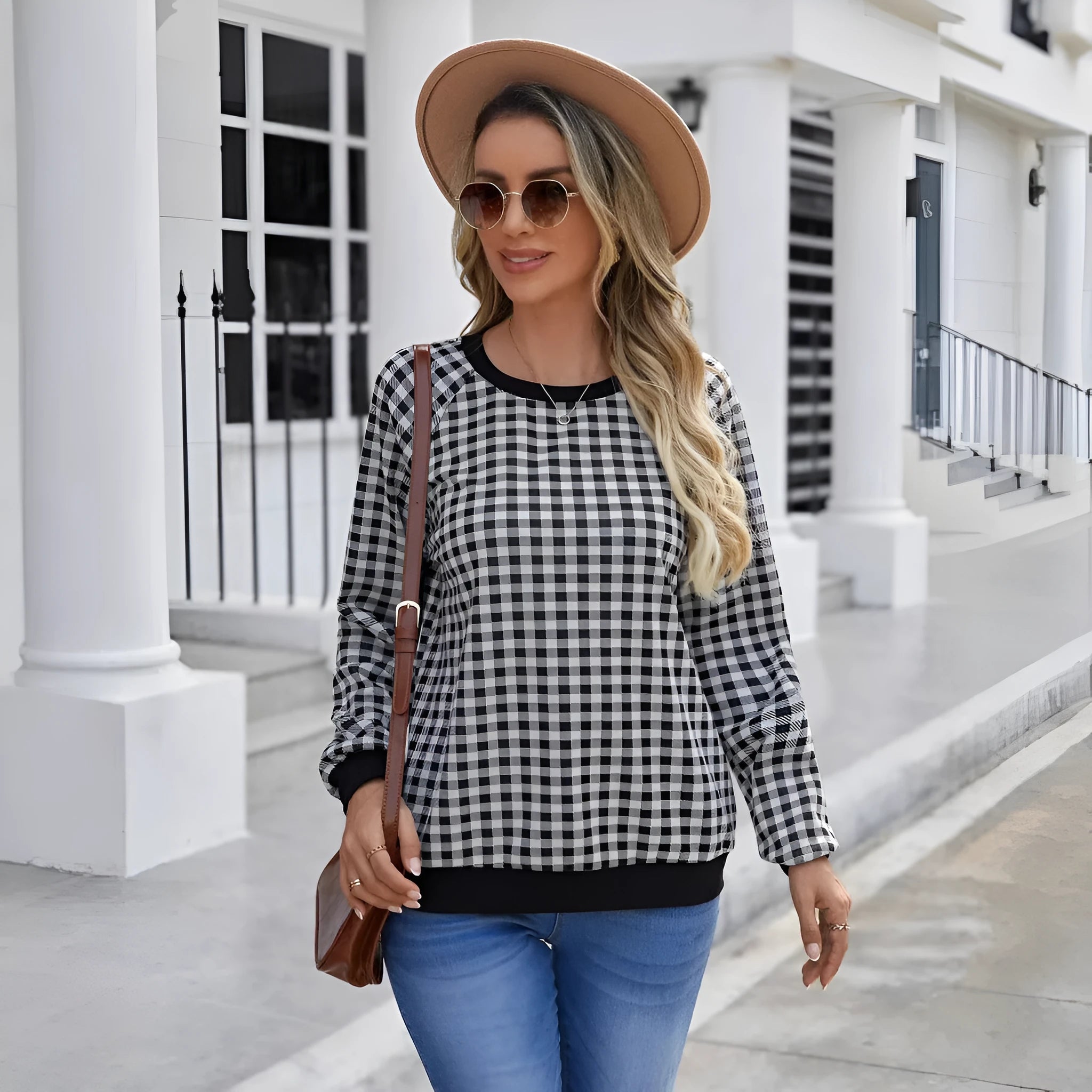 Black plaid print pullover sweater with long sleeves on mannequin