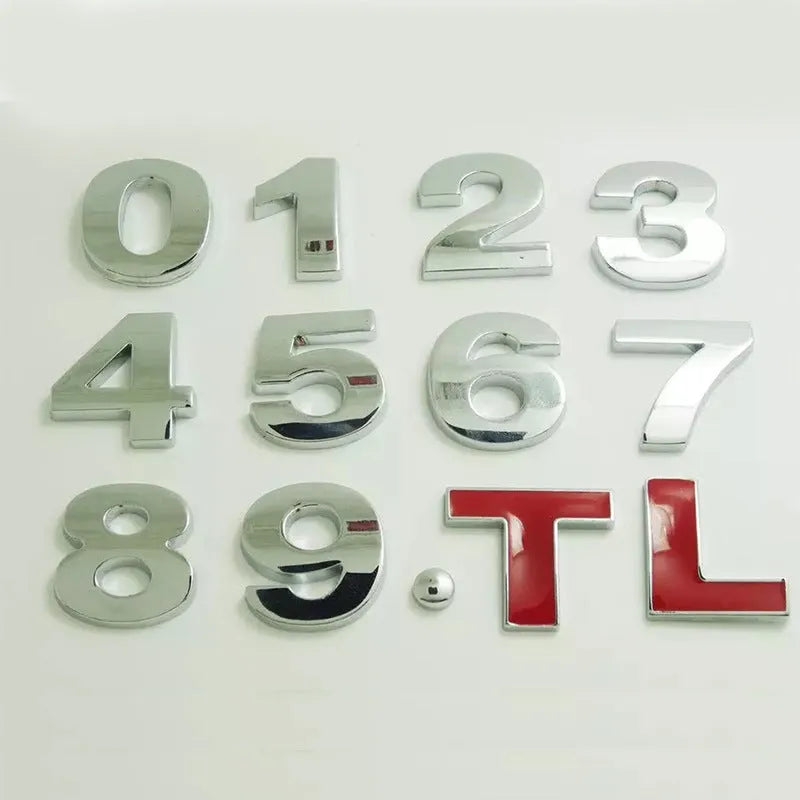 3D metal car letter sticker in zinc alloy, shown in black and silver finishes, approx. 2.5 cm in size.