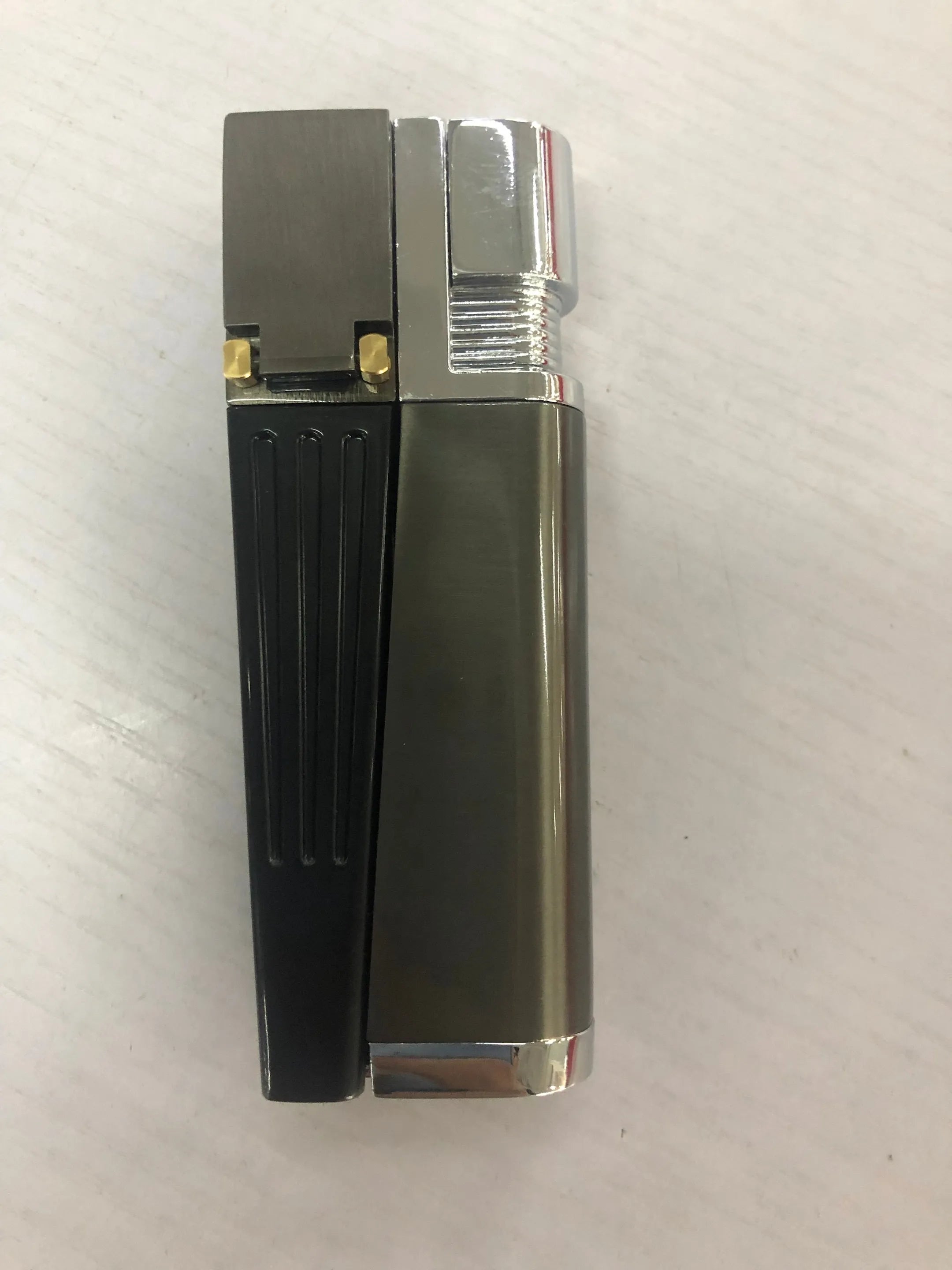 Silver foldable metal pipe lighter shown open, revealing lighter mechanism and small storage compartment.