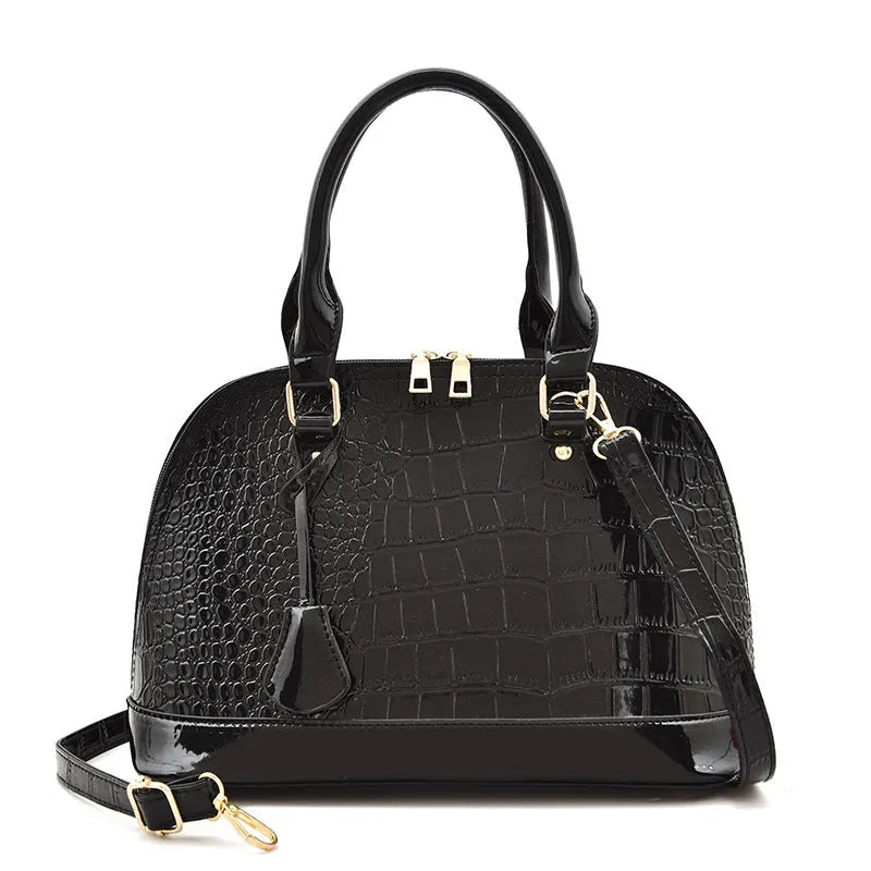 Shell-shaped shiny PU leather crossbody shoulder bag showing black, brown, and red colour options