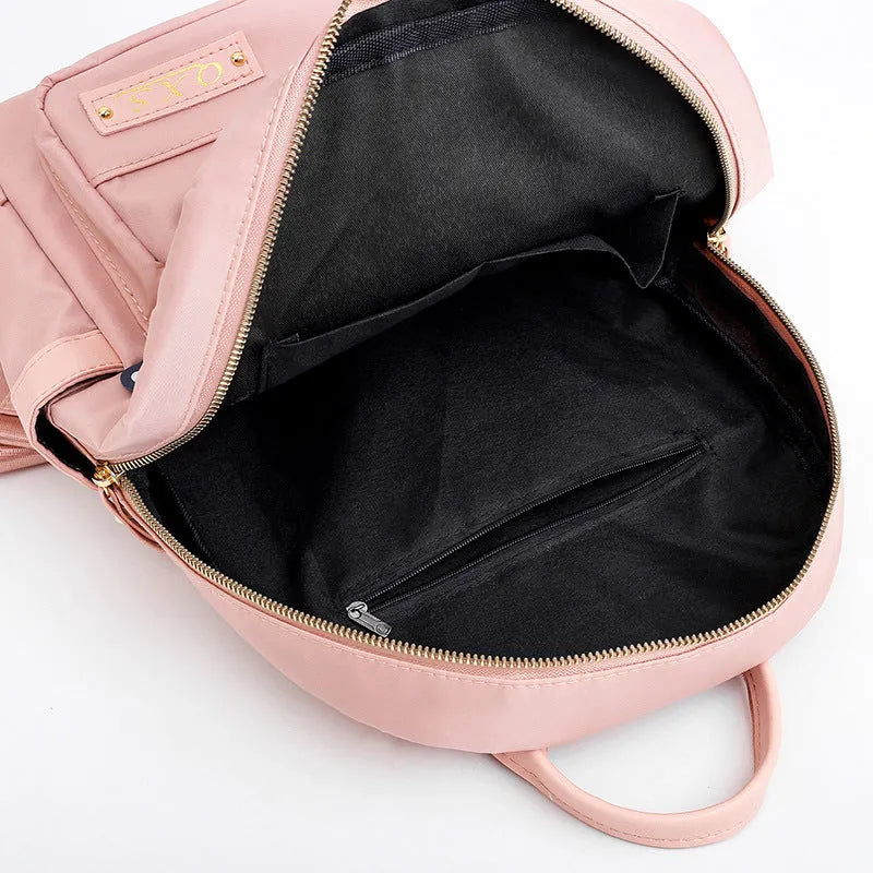 Women's casual nylon backpack in black or pink with water-resistant features and internal organisation compartments